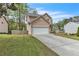 Inviting home featuring a two-car garage, well-manicured lawn, and charming curb appeal at 4567 Hickory Forest Nw Dr, Acworth, GA 30102