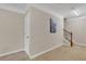 Upstairs hallway boasts neutral walls, white trim, and staircase with black wrought iron railing at 4567 Hickory Forest Nw Dr, Acworth, GA 30102