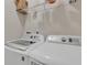Bright laundry room with modern washer and dryer, and wire shelving at 4567 Hickory Forest Nw Dr, Acworth, GA 30102