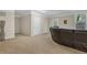 Living room with plush carpeting and a comfortable leather sectional sofa at 4567 Hickory Forest Nw Dr, Acworth, GA 30102