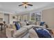 Bright living room features a large, comfortable sectional sofa and a ceiling fan at 4567 Hickory Forest Nw Dr, Acworth, GA 30102