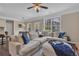Bright living room featuring a large sectional sofa, ottoman, and dark hardwood floors at 4567 Hickory Forest Nw Dr, Acworth, GA 30102
