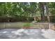 The backyard features a small deck and a line of trees providing extra shade and privacy at 525 Forest Pl, Roswell, GA 30076