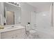 Bathroom featuring a white vanity, marble-look flooring, a shower-tub and white tiling at 525 Forest Pl, Roswell, GA 30076