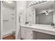 Clean bathroom with vanity, sink, large mirror, and a walk-in shower at 525 Forest Pl, Roswell, GA 30076