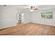 Spacious bedroom with hardwood floors, natural light, and en-suite bathroom at 525 Forest Pl, Roswell, GA 30076
