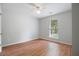 Bright bedroom featuring wood-look flooring, a window and neutral paint at 525 Forest Pl, Roswell, GA 30076