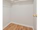 Walk-in closet featuring built-in shelving and hardwood flooring at 525 Forest Pl, Roswell, GA 30076