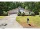Charming single-Gathering home featuring stone accents, a two-car garage, and lush landscaping at 525 Forest Pl, Roswell, GA 30076