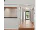 Hallway featuring hardwood floors, light walls, and views of the front door and adjacent rooms at 525 Forest Pl, Roswell, GA 30076