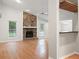 Spacious living room with a stone fireplace, wood floors, and ample natural light at 525 Forest Pl, Roswell, GA 30076