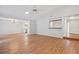 Open-concept living area with hardwood floors, neutral walls, and modern lighting fixtures at 525 Forest Pl, Roswell, GA 30076