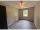 A bedroom with ample natural light, fan, and neutral walls at 595 Crowell Rd, Porterdale, GA 30014