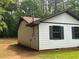 View of home showcasing white siding and updated dark trim at 595 Crowell Rd, Porterdale, GA 30014