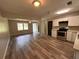 Spacious living room next to kitchen with wood floors and bright lighting at 595 Crowell Rd, Porterdale, GA 30014