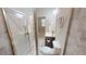 Bathroom featuring tiled floor, toilet, vanity with sink and mirror, and a tiled shower with glass door at 753 Topsail Ln, Alpharetta, GA 30005