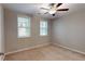 Cozy bedroom featuring carpeted floors, window, ceiling fan, and ample natural light at 753 Topsail Ln, Alpharetta, GA 30005