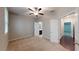 Bedroom with neutral carpet and walls and view of bathroom and garage at 753 Topsail Ln, Alpharetta, GA 30005