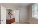 Bedroom featuring a staircase view, neutral walls, carpet, and a window with natural light and blinds at 753 Topsail Ln, Alpharetta, GA 30005