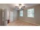 Bedroom with neutral walls, carpet, ceiling fan, and natural light from two windows dressed with string lights at 753 Topsail Ln, Alpharetta, GA 30005