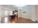 Well-lit dining area with wood floors, a modern chandelier, and seamless access to the kitchen at 753 Topsail Ln, Alpharetta, GA 30005