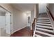 Bright hallway featuring hardwood floors, staircase, and doors leading to various rooms at 753 Topsail Ln, Alpharetta, GA 30005