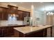 Spacious kitchen features stainless steel appliances, granite countertops and dark wood cabinets at 753 Topsail Ln, Alpharetta, GA 30005