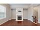 Cozy living room with hardwood floors and a charming fireplace, complemented by natural light at 753 Topsail Ln, Alpharetta, GA 30005