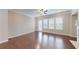 Open-concept living room with hardwood floors, recessed lighting, and access to a back patio at 753 Topsail Ln, Alpharetta, GA 30005