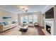 Bright and airy living room features plush seating, a fireplace, and a neutral palette at 753 Topsail Ln, Alpharetta, GA 30005