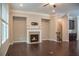 Spacious living room features hardwood flooring, fireplace and access to staircase and dinning area at 753 Topsail Ln, Alpharetta, GA 30005