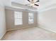 Bedroom featuring neutral walls, carpet, two large windows, and a tray ceiling with ceiling fan at 753 Topsail Ln, Alpharetta, GA 30005