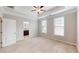 Spacious main bedroom featuring two windows, neutral walls, tray ceilings, and a ceiling fan with light fixture at 753 Topsail Ln, Alpharetta, GA 30005