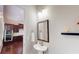Charming powder room featuring pedestal sink and decorative mirror adjacent to the kitchen at 753 Topsail Ln, Alpharetta, GA 30005