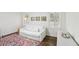 Cozy bedroom featuring hardwood floors, a colorful rug and lots of natural light at 1410 Lively Ridge Ne Rd, Atlanta, GA 30329