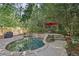Backyard features a private pool with stone surround, landscaping, and umbrella-covered seating at 1410 Lively Ridge Ne Rd, Atlanta, GA 30329