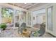 Relaxing sunroom with stone floor, ceiling fan, and a view to the backyard at 1410 Lively Ridge Ne Rd, Atlanta, GA 30329