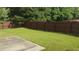Spacious backyard with lush green grass and a privacy fence, perfect for outdoor entertaining at 1481 Park Knoll Trl, Lawrenceville, GA 30043