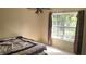 Bedroom features a ceiling fan and a window bringing in lots of natural light at 1481 Park Knoll Trl, Lawrenceville, GA 30043