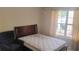 Inviting bedroom with a large window and a comfortable chair at 1481 Park Knoll Trl, Lawrenceville, GA 30043