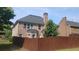 View of the rear exterior of the property, fence, and yard at 1481 Park Knoll Trl, Lawrenceville, GA 30043