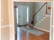 Foyer with hardwood floors, staircase, and front door, creating a welcoming entrance to the home at 1481 Park Knoll Trl, Lawrenceville, GA 30043