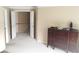 Spacious hallway featuring a decorative wood dresser and a view of the upper staircase at 1481 Park Knoll Trl, Lawrenceville, GA 30043