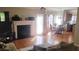Bright living room features hardwood floors, a fireplace, and an adjacent dining area at 1481 Park Knoll Trl, Lawrenceville, GA 30043