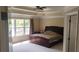 Spacious main bedroom with a tray ceiling, large window, and neutral decor, providing a serene retreat at 1481 Park Knoll Trl, Lawrenceville, GA 30043