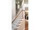 Carpeted staircase with a wooden railing leads to the upper level of the home at 1481 Park Knoll Trl, Lawrenceville, GA 30043