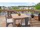 Outdoor deck with a grill, table, and chairs, offering a view of the water and neighboring houses at 1544 Overview Cir, Lawrenceville, GA 30044