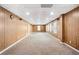 Large finished basement featuring wood walls and new carpet at 1544 Overview Cir, Lawrenceville, GA 30044