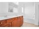 Bathroom with a double vanity, large mirror, and separate tub, offering a clean and bright space at 1544 Overview Cir, Lawrenceville, GA 30044