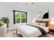 Bright bedroom with a large window, neutral decor, hardwood floors, and modern furniture at 1544 Overview Cir, Lawrenceville, GA 30044